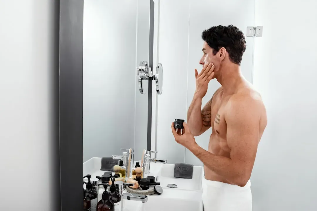 Essential grooming products and skincare tools arranged for a basic men's grooming routine, featured in looksmaxxing advice g